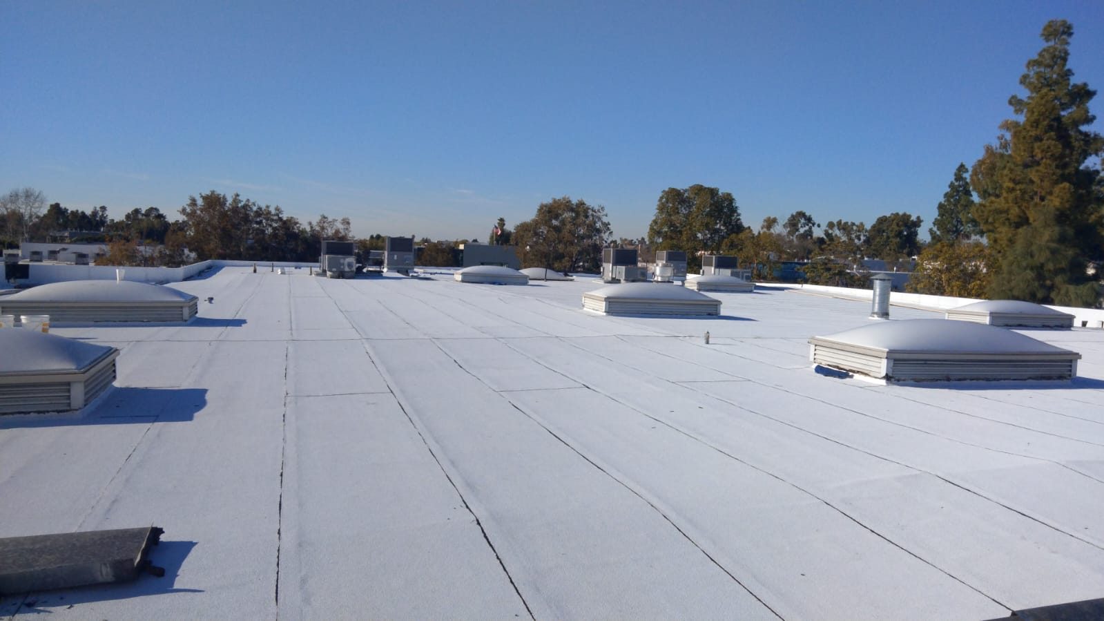 flat roof with white reflective coating on a home in Irvine, California — a Samuel Roofing Inc. job photo