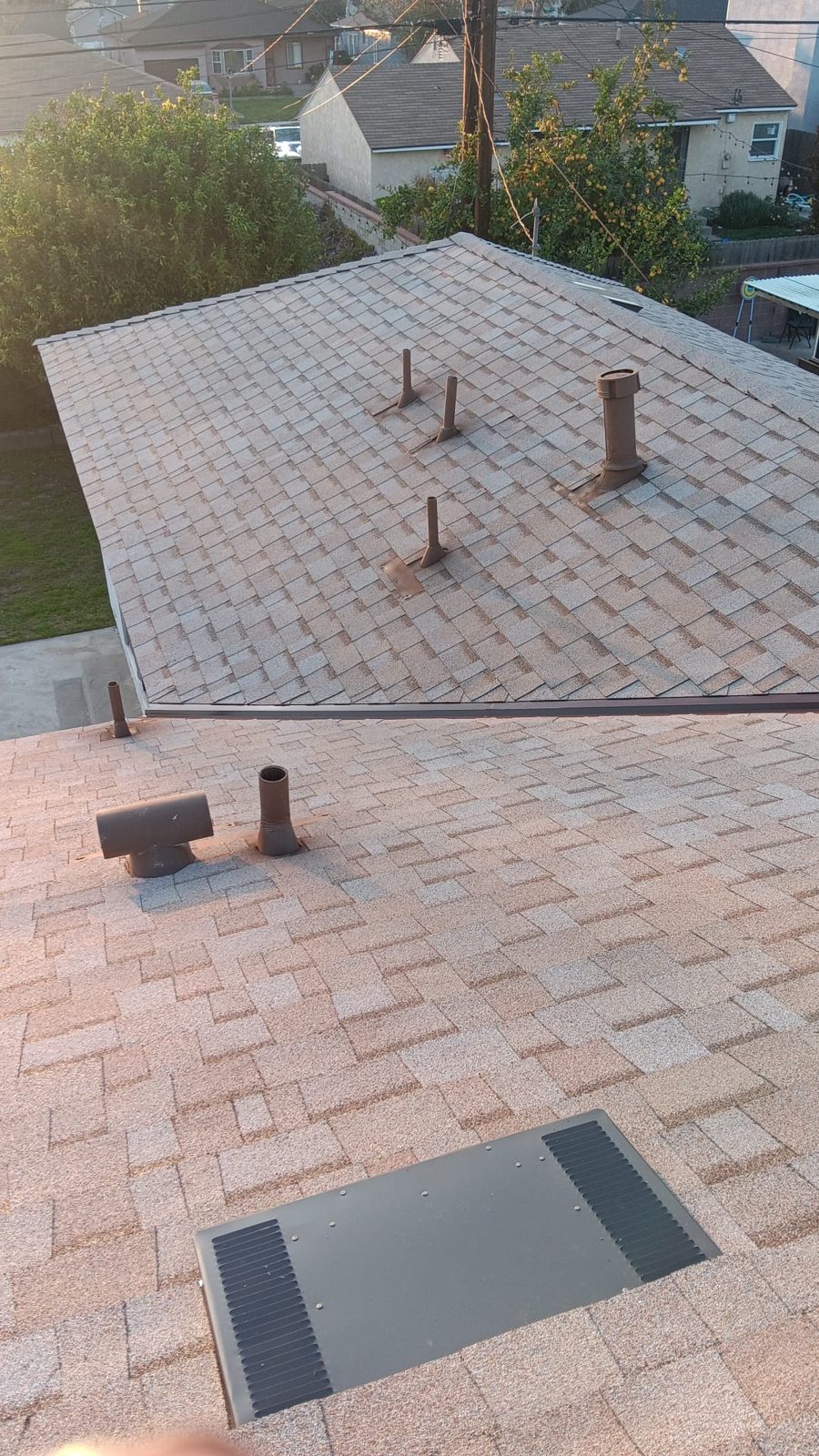 flat roof with white reflective coating on a home in Lakewood, California — a Samuel Roofing Inc. job photo