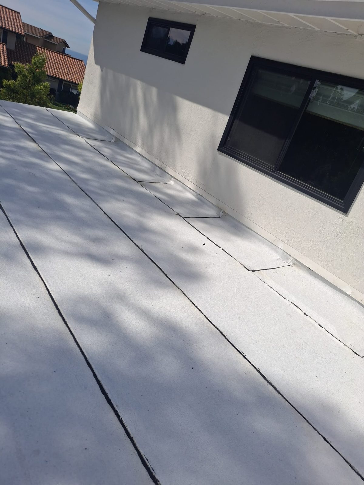 flat roof with white reflective coating on a home in Pacific Palisades, California — a Samuel Roofing Inc. job photo