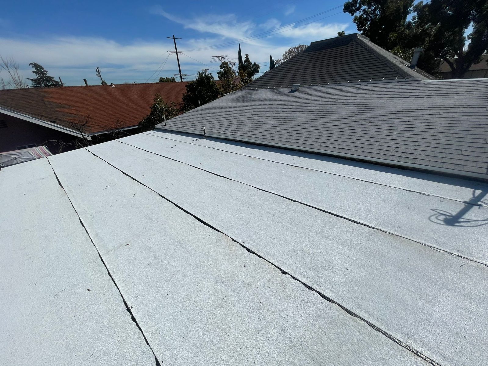 flat roof with white reflective coating on a home in Pomona, California — a Samuel Roofing Inc. job photo