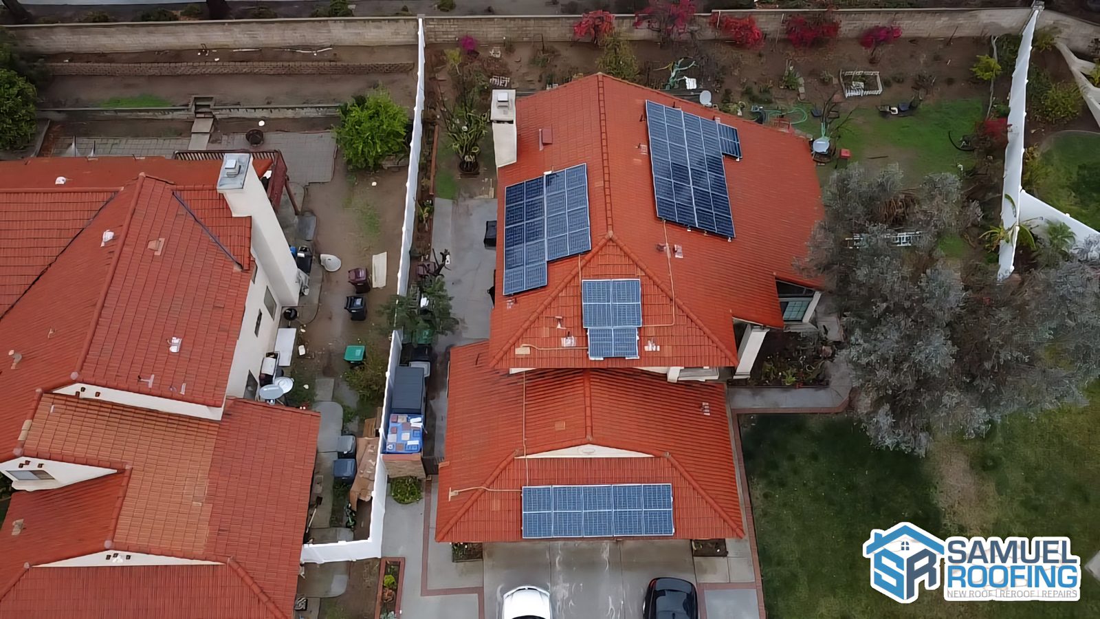 Drone photo of a clay tile roof with solar panels by Samuel Roofing Inc. (portfolio photo)