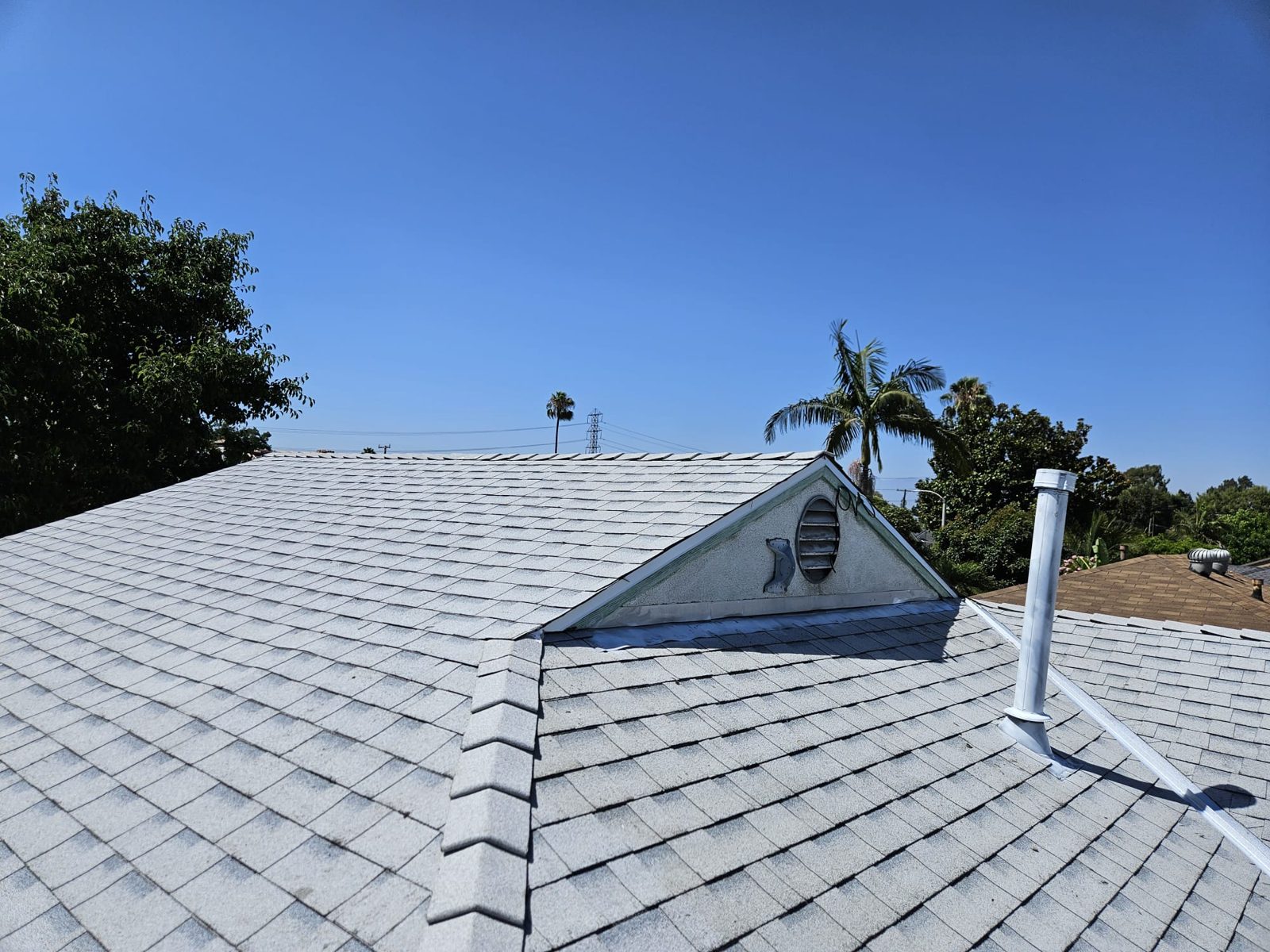 Light cool-roof architectural shingles installed by Samuel Roofing Inc. (portfolio photo)