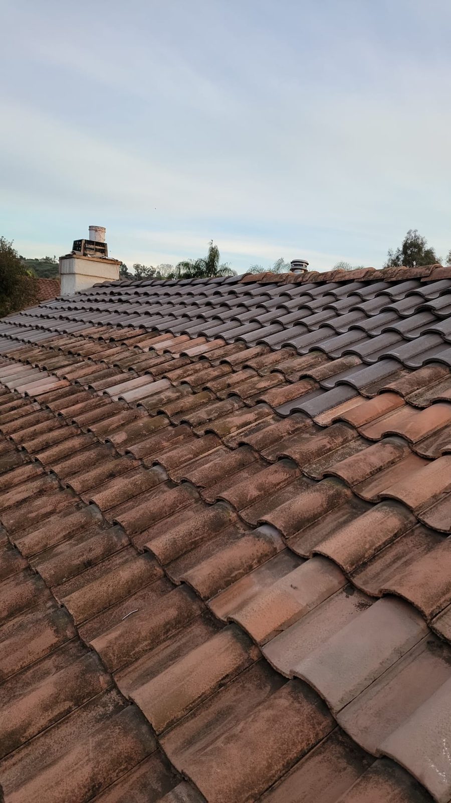A tile reset in progress: new replacement S-tile laid next to the original tile, a Samuel Roofing Inc. portfolio photo