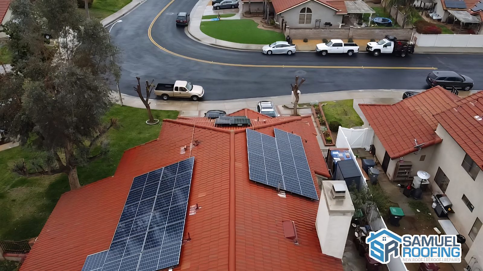 Drone photo of a concrete tile roof with solar panels, a Samuel Roofing Inc. portfolio photo